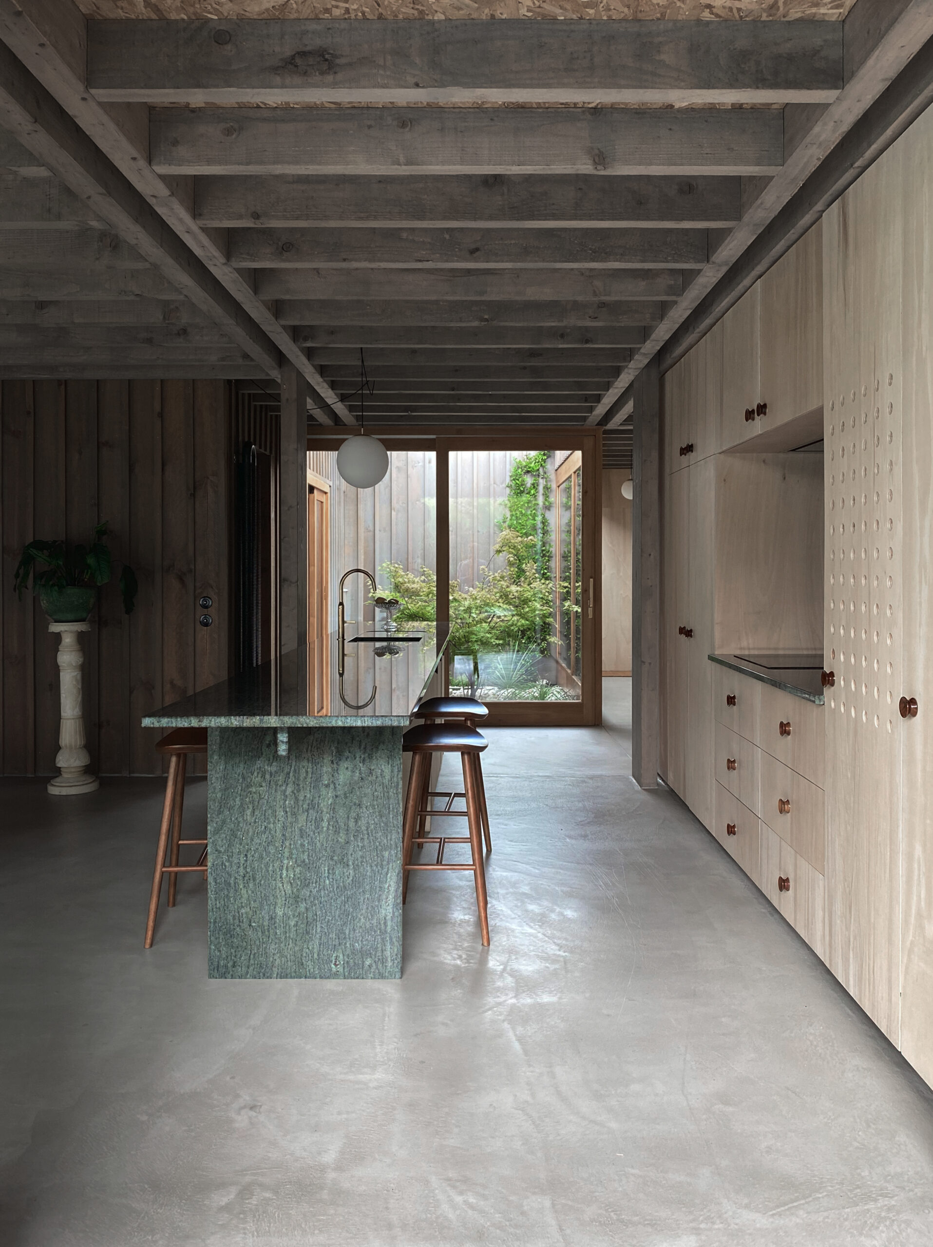 Vue de l'espace cuisine et sa transparence sur le patio / jaq